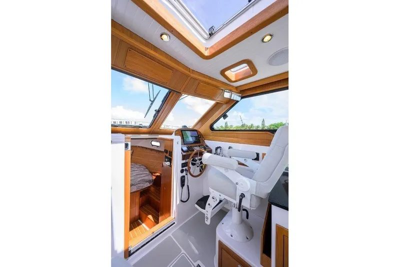 Slide: The Image of Luxurious 2022 True North 34 yacht interior with wooden accents and modern helm station. - 61