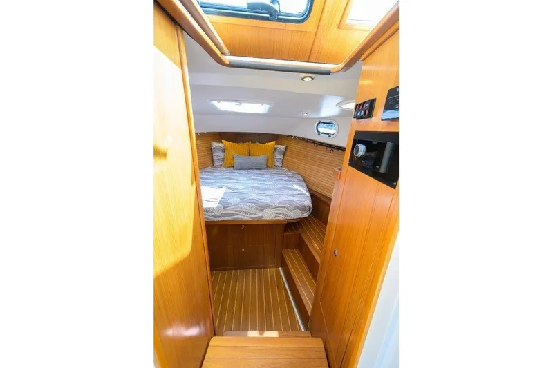 Slide: The Image of Cozy cabin interior of 2022 True North 34 yacht with wooden finish and skylight. - 72