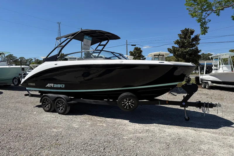 Slide: The Image of 2023 Yamaha Boats AR250 on trailer, displayed outdoors under clear blue sky. - 10