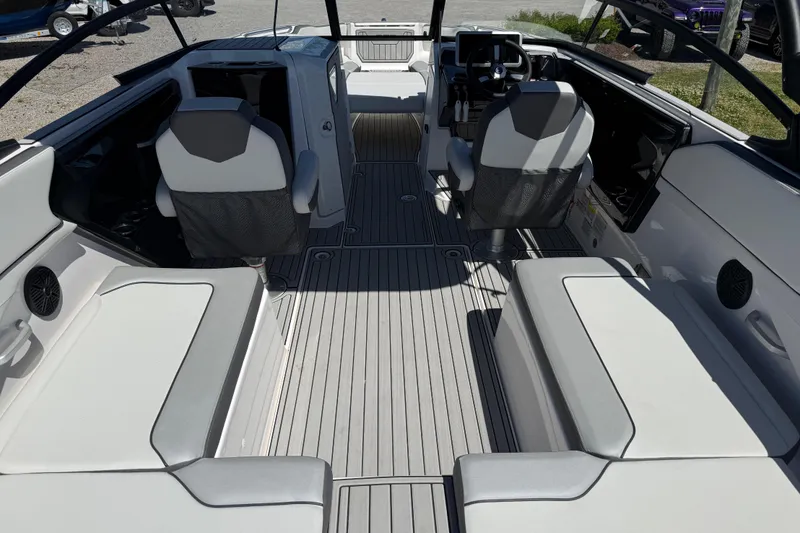 Slide: The Image of 2023 Yamaha Boats AR250 interior with sleek seating and modern dashboard design. - 18