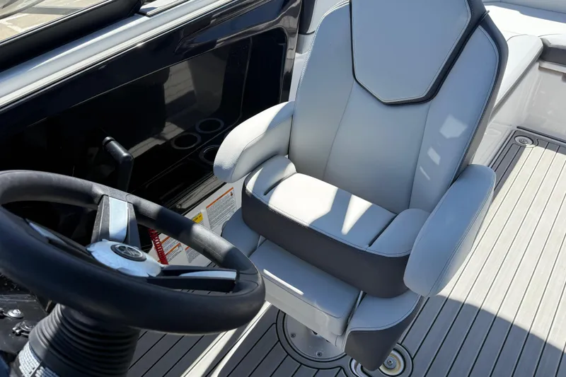 Slide: The Image of 2023 Yamaha Boats AR250 helm with steering wheel and captain's chair. - 24