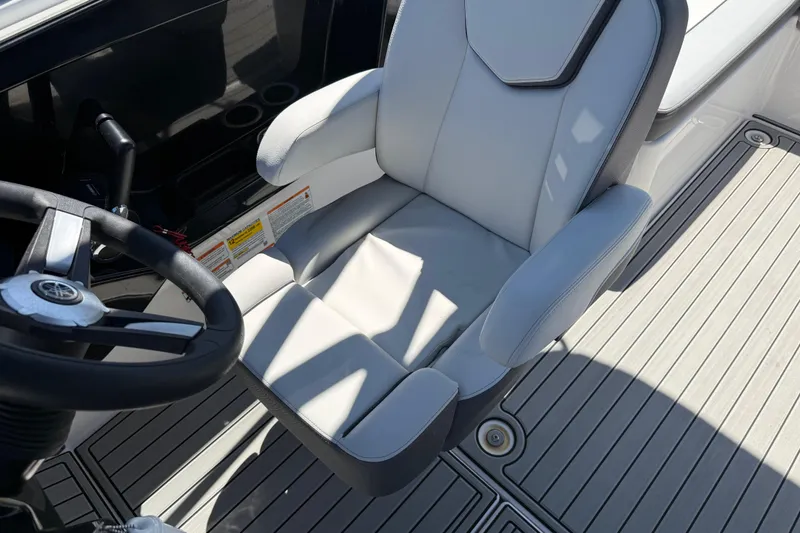 Slide: The Image of Captain's seat and steering wheel of 2023 Yamaha Boats AR250, featuring sleek design and comfort. - 25