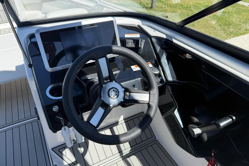 Slide: The Image of 2023 Yamaha Boats AR250 steering console with modern controls and display. - 26