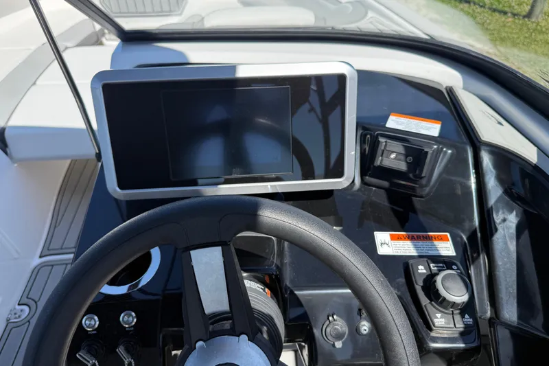 Slide: The Image of 2023 Yamaha Boats AR250 dashboard with steering wheel and touchscreen display. - 27