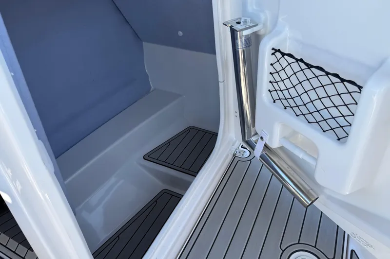 Slide: The Image of 2023 Yamaha AR250 boat interior with storage net and sleek flooring. - 30