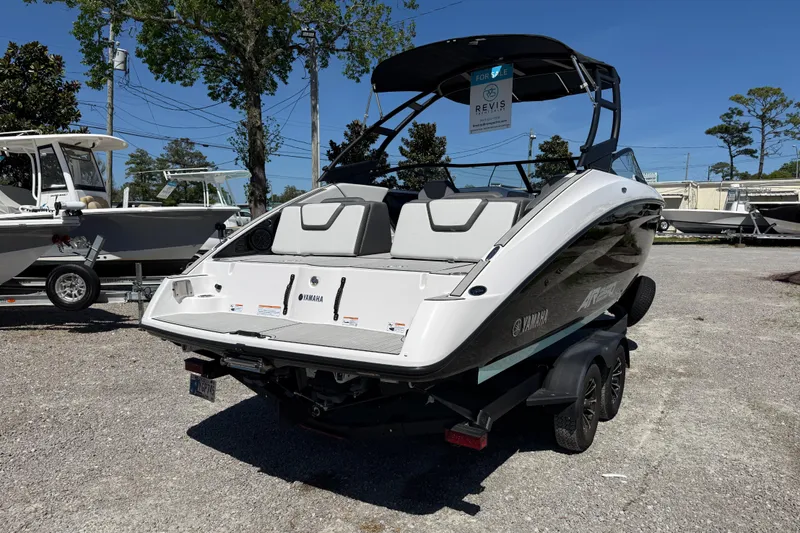 Slide: The Image of 2023 Yamaha Boats AR250 on trailer, displayed outdoors, ready for sale. - 7