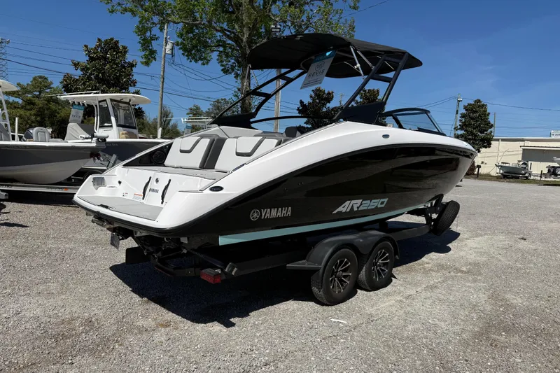 Slide: The Image of 2023 Yamaha Boats AR250 on trailer, parked outdoors under clear blue sky. - 8