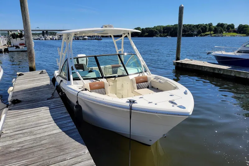 The Image of 2021 Cobia 240 Dual Console boat docked at a marina on a sunny day. - 0