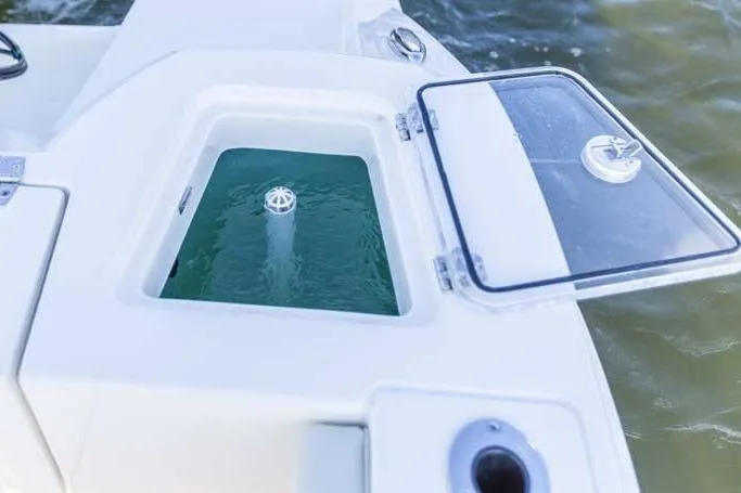 Slide: The Image of Manufacturer Provided Image: 2021 Cobia 240 Dual Console livewell with open lid on the water. - 12