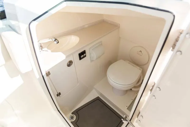 Slide: The Image of Manufacturer Provided Image: 2021 Cobia 240 Dual Console boat interior bathroom with sink and toilet. - 14