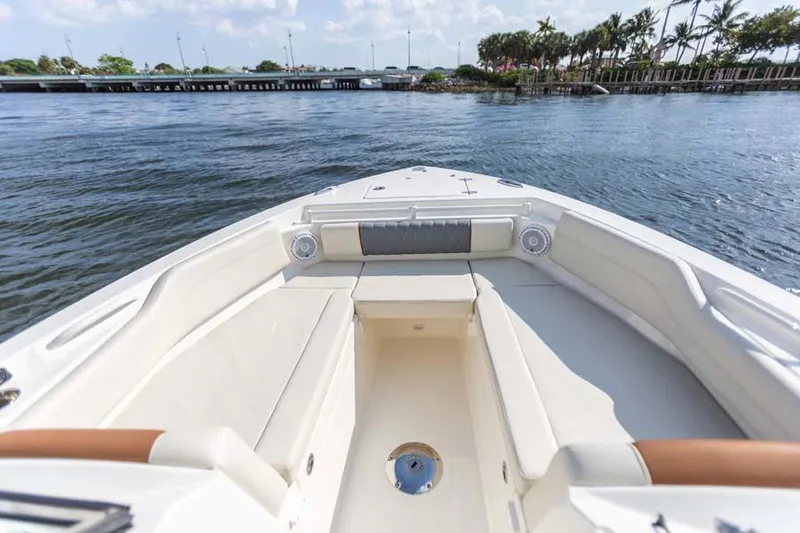 Slide: The Image of Manufacturer Provided Image: 2021 Cobia 240 Dual Console boat interior with spacious seating on the water. - 6
