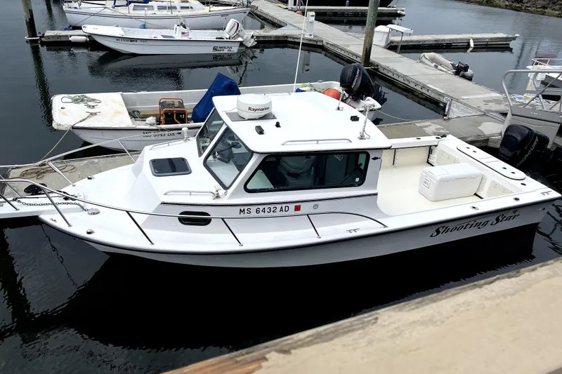 The Image of 2004 C-Hawk 25 Sport Cabin boat docked at marina, named "Shooting Star." - 0