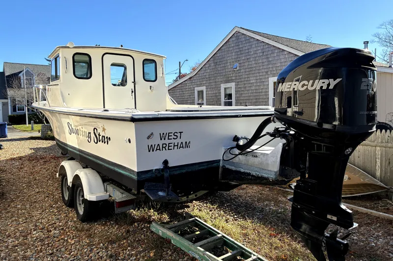 Slide: The Image of 2004 C-Hawk 25 Sport Cabin boat with Mercury 250 engine, named "Shooting Star." - 2