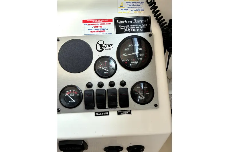 Slide: The Image of Control panel of a 2004 C-Hawk 25 Sport Cabin boat with gauges and switches. - 6