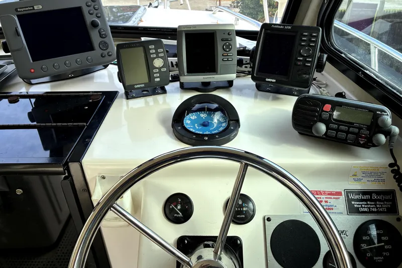 Slide: The Image of 2004 C-Hawk 25 Sport Cabin dashboard with navigation instruments and steering wheel. - 7
