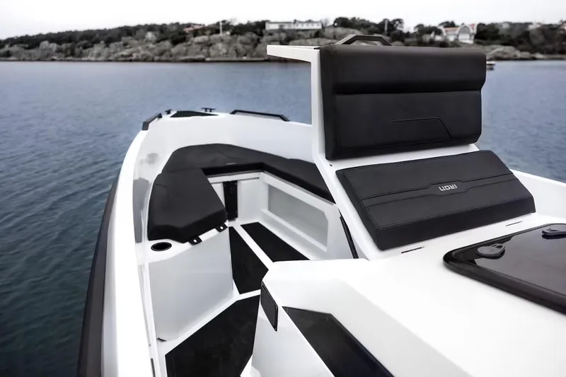 Slide: The Image of Manufacturer Provided Image: Modern Iron 907 boat interior, 2025 model, featuring sleek seating and scenic water backdrop. - 3