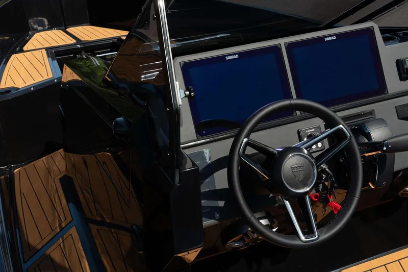 Slide: The Image of Manufacturer Provided Image: 2025 Iron 907 boat cockpit with dual Simrad displays and sleek steering wheel. - 4