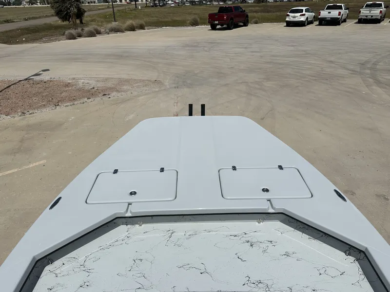 Slide: The Image of Front view of a 2026 Shoalwater 23 CAT RSD boat on a parking lot. - 17