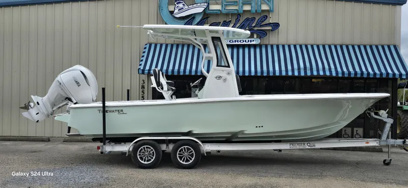 The Image of 2026 Tidewater 2500 Carolina Bay boat on trailer in front of building. - 1