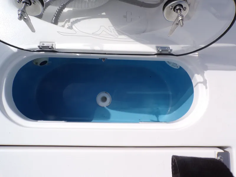 Slide: The Image of Tidewater 2500 Carolina Bay 2026 boat hatch with blue interior. - 29