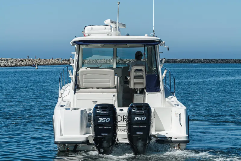 Slide: The Image of 2016 Boston Whaler 315 Conquest boat with dual 350 engines on calm water. - 10