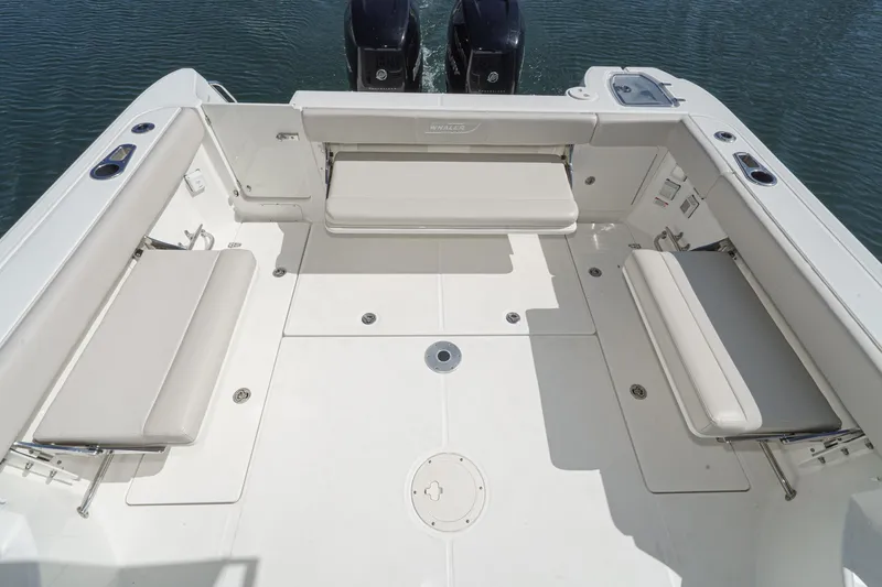 Slide: The Image of 2016 Boston Whaler 315 Conquest boat deck with seating and dual engines. - 12