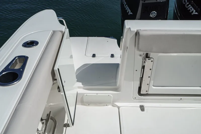 Slide: The Image of 2016 Boston Whaler 315 Conquest boat deck with open hatch and seating area. - 14
