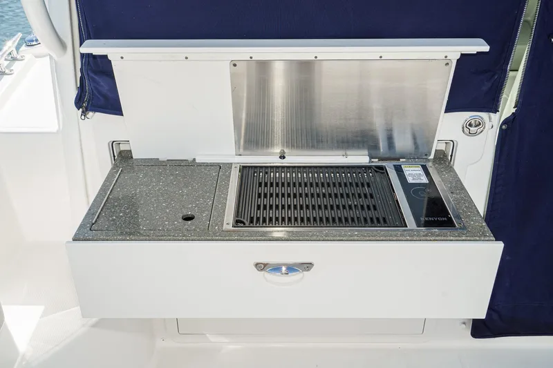 Slide: The Image of Outdoor grill station on 2016 Boston Whaler 315 Conquest boat. - 18