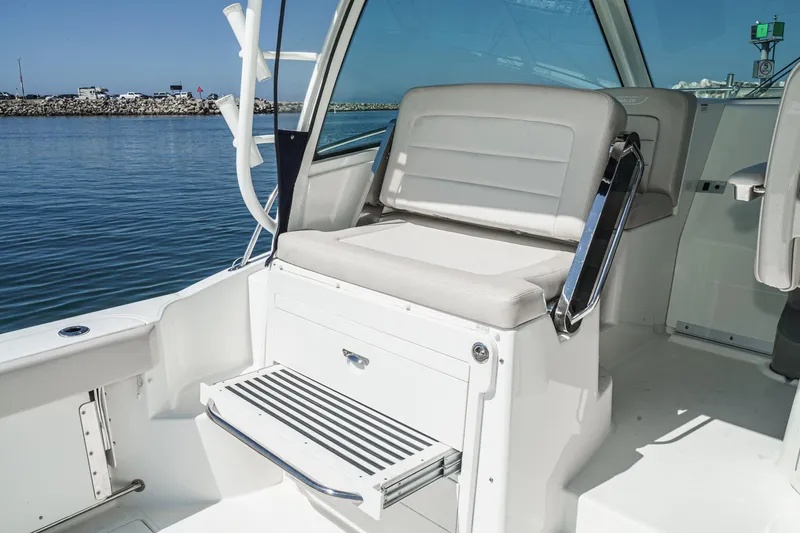 Slide: The Image of 2016 Boston Whaler 315 Conquest boat interior with seating and ocean view. - 20