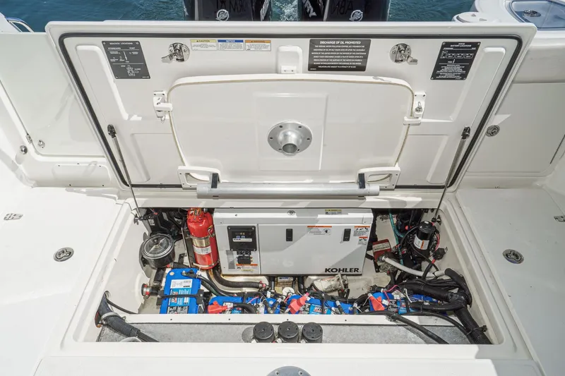 Slide: The Image of Engine compartment of 2016 Boston Whaler 315 Conquest with Kohler generator and fire extinguisher. - 22