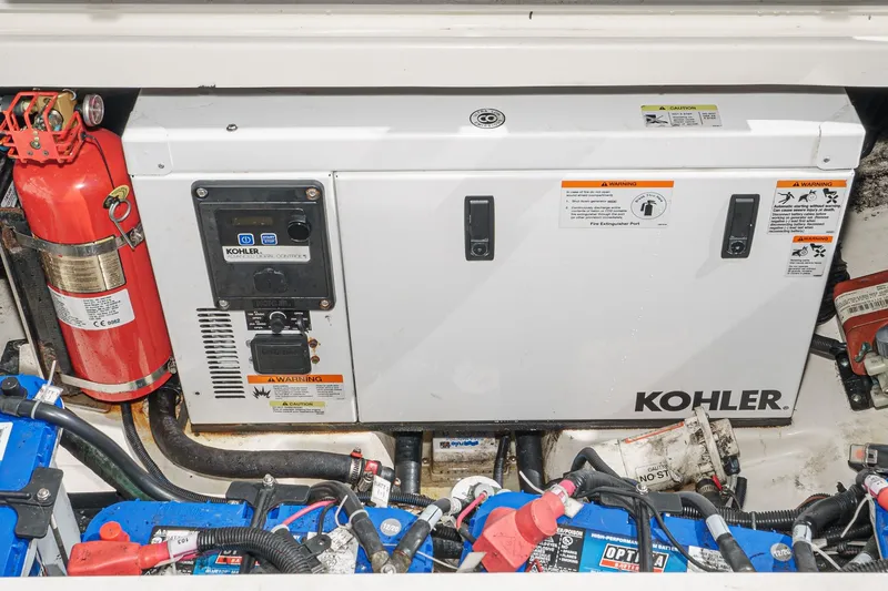 Slide: The Image of Engine compartment of 2016 Boston Whaler 315 Conquest with Kohler generator and fire extinguisher. - 23