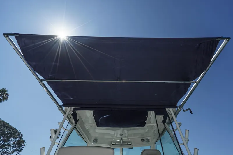 Slide: The Image of Boston Whaler 315 Conquest 2016 boat with sunshade under bright blue sky. - 29