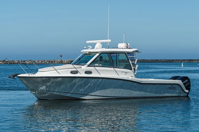 Slide: The Image of 2016 Boston Whaler 315 Conquest boat on calm water, clear sky background. - 3