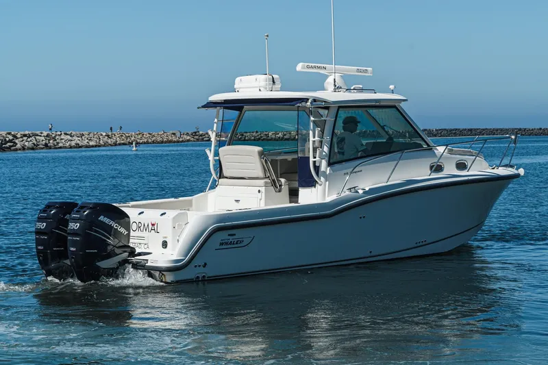 Slide: The Image of 2016 Boston Whaler 315 Conquest boat cruising on calm waters. - 4