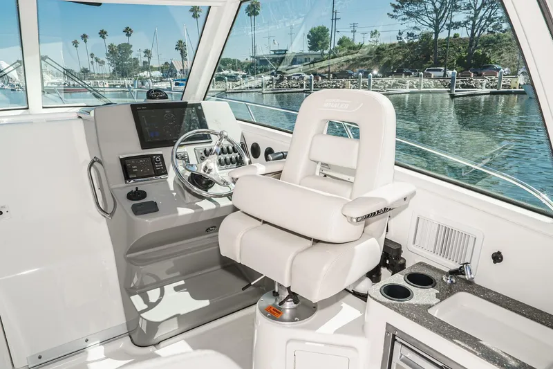 Slide: The Image of 2016 Boston Whaler 315 Conquest helm with luxurious captain's chair and advanced navigation controls. - 42
