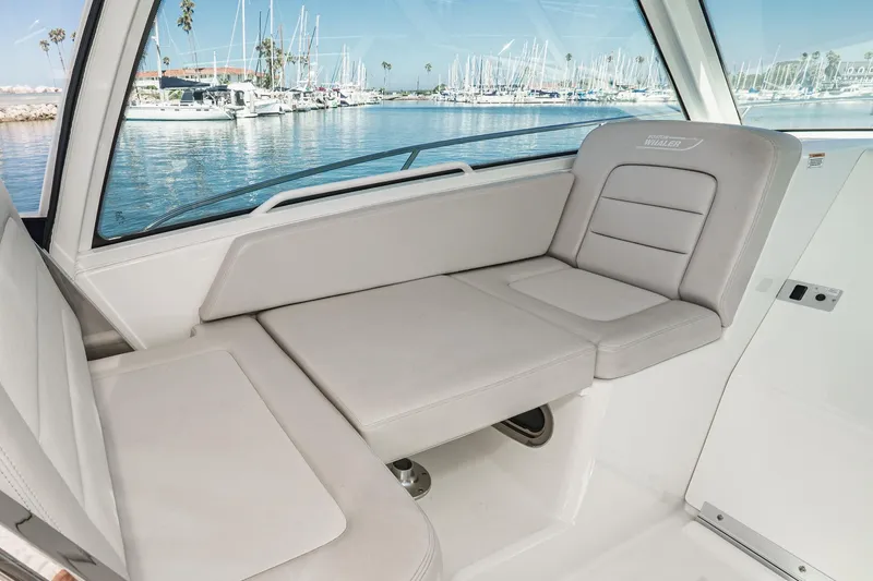 Slide: The Image of Interior seating of 2016 Boston Whaler 315 Conquest boat with marina view. - 43