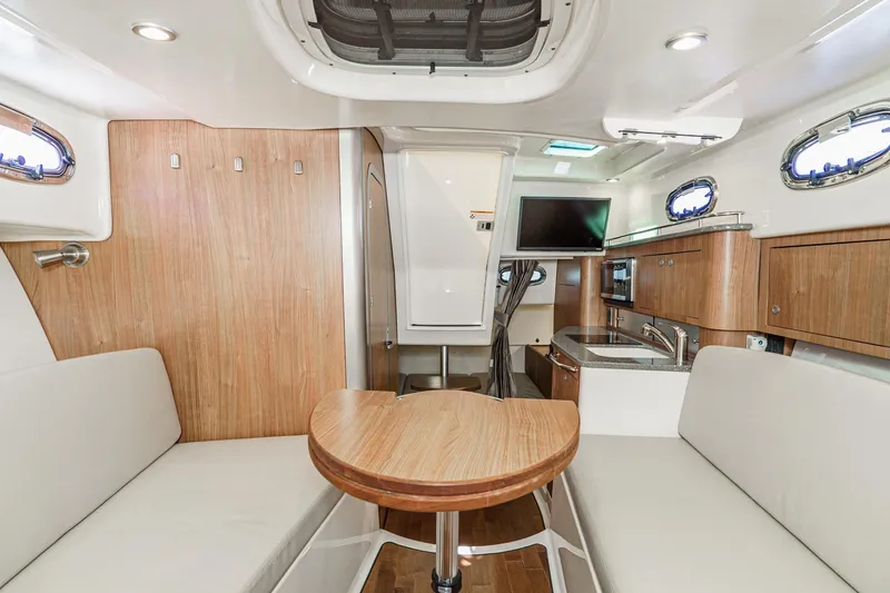 Slide: The Image of Interior of 2016 Boston Whaler 315 Conquest, featuring wood accents and modern amenities. - 45