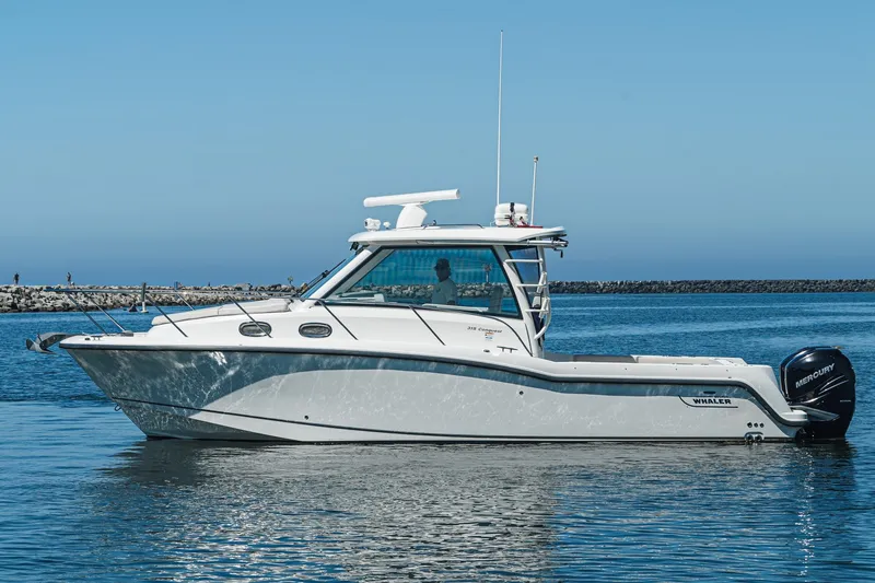 Slide: The Image of 2016 Boston Whaler 315 Conquest boat on calm water, clear sky background. - 5