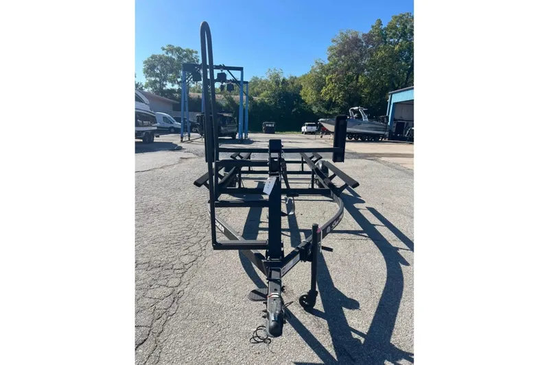 Slide: The Image of Trailer for 2025 Sun Tracker Party Barge 18 DLX, parked outdoors. - 2