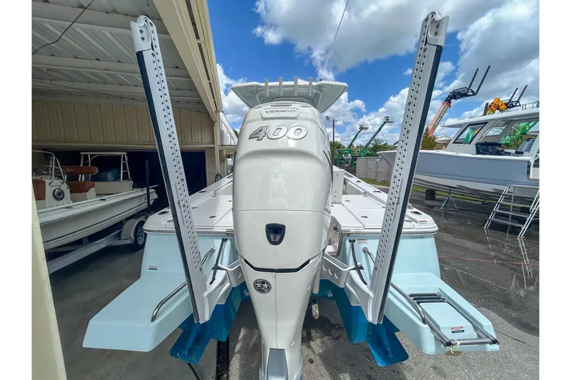 Slide: The Image of 2023 Robalo 266 Cayman boat with powerful engine and sleek design, docked outdoors. - 3