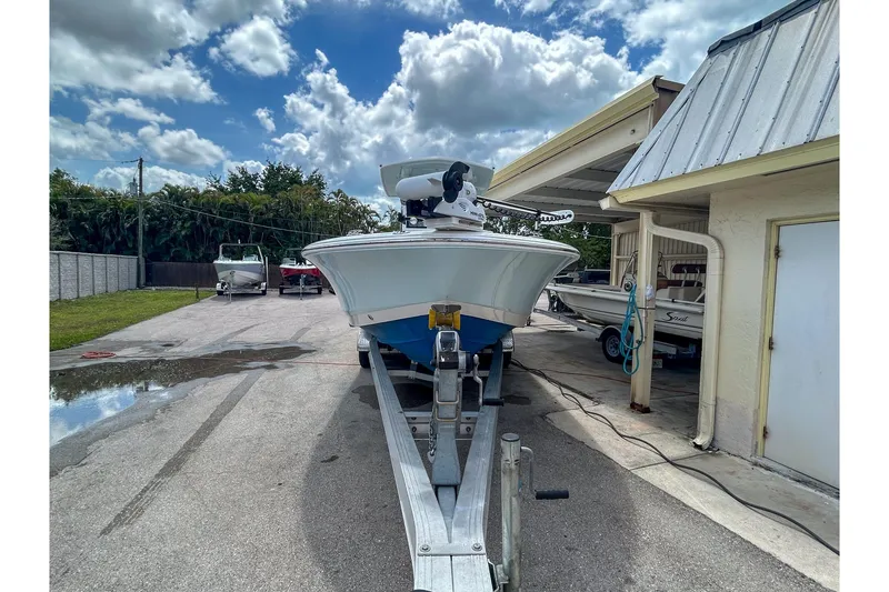 Slide: The Image of 2023 Robalo 266 Cayman boat on trailer under cloudy sky. - 4