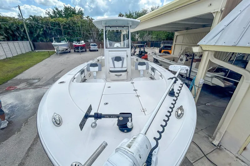 Slide: The Image of 2023 Robalo 266 Cayman boat docked, showcasing spacious deck and modern design. - 6