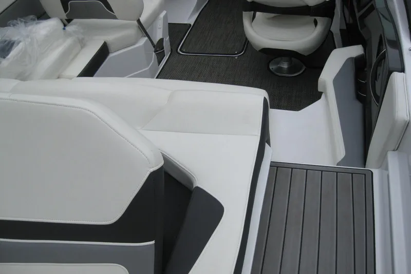 Slide: The Image of Interior of a 2015 Monterey 218SS Super Sport boat with white seating and gray flooring. - 11