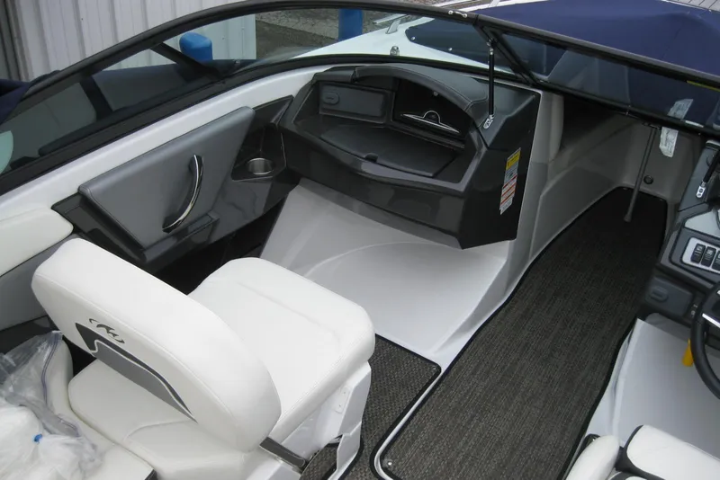Slide: The Image of Interior of a 2015 Monterey 218SS Super Sport boat, featuring sleek seating and dashboard. - 12