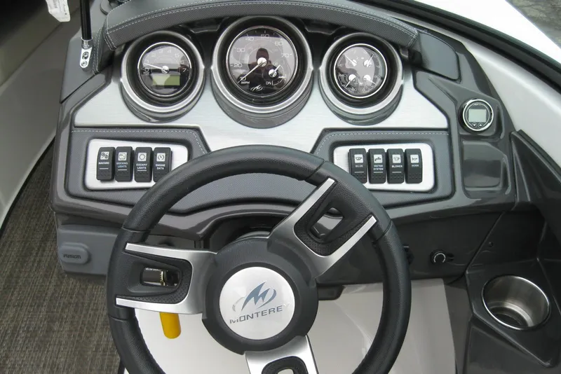 Slide: The Image of Dashboard of a 2015 Monterey 218SS Super Sport boat with steering wheel and gauges. - 15