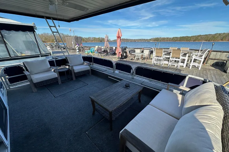 Slide: The Image of Luxurious 2000 Sumerset 16x73 houseboat with spacious deck and comfortable seating by the water. - 1