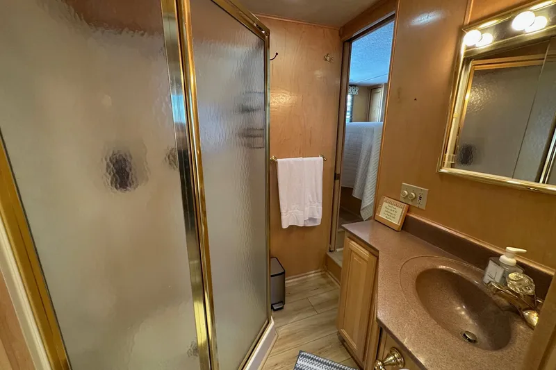 Slide: The Image of Bathroom interior of 2000 Sumerset 16x73 houseboat with shower and vanity. - 10