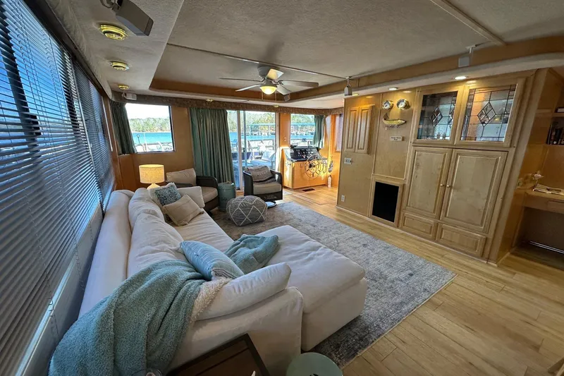 Slide: The Image of Luxurious 2000 Sumerset 16x73 houseboat interior with cozy seating and elegant wood cabinetry. - 4