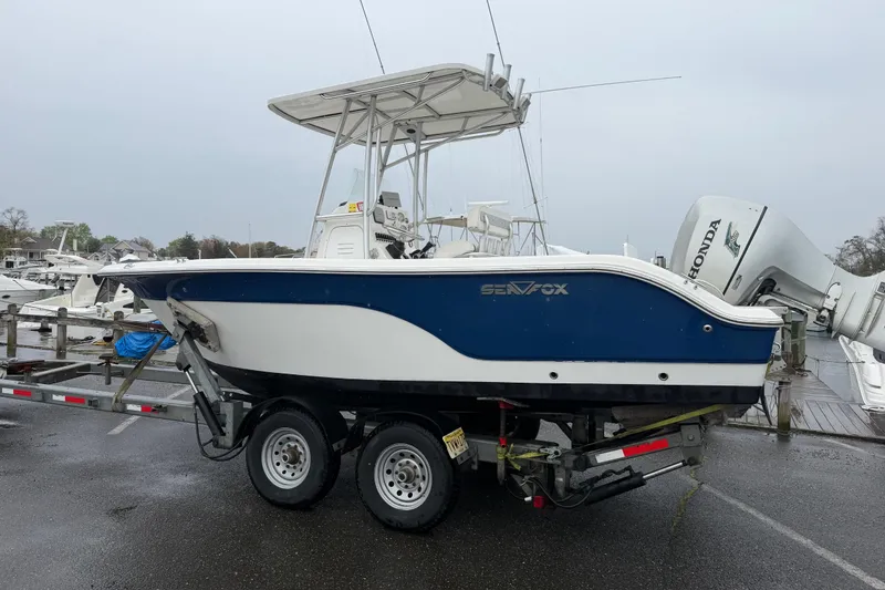 Slide: The Image of 2010 Sea Fox 216 Center Console boat on trailer, parked at marina. - 10