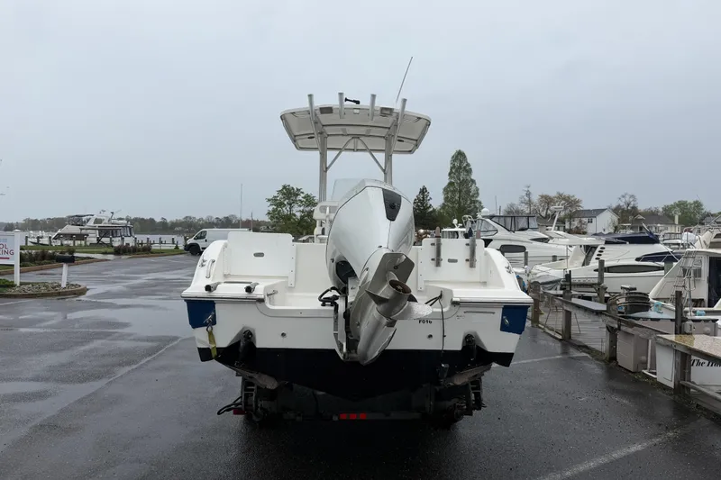 Slide: The Image of 2010 Sea Fox 216 Center Console boat at marina, rear view with outboard motor. - 12
